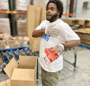 This is a picture of Anthony Griffin volunteering at the Food Bank of CNY with United Way's day of caring.