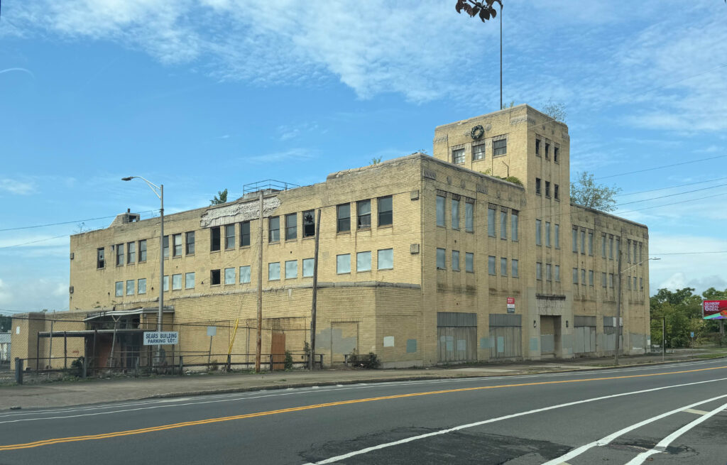 Existing exterior of the former Sears building at 1300 South Salina Street in Syracuse, NY, before its planned redevelopment into the ON-RAMP CNY workforce training hub.